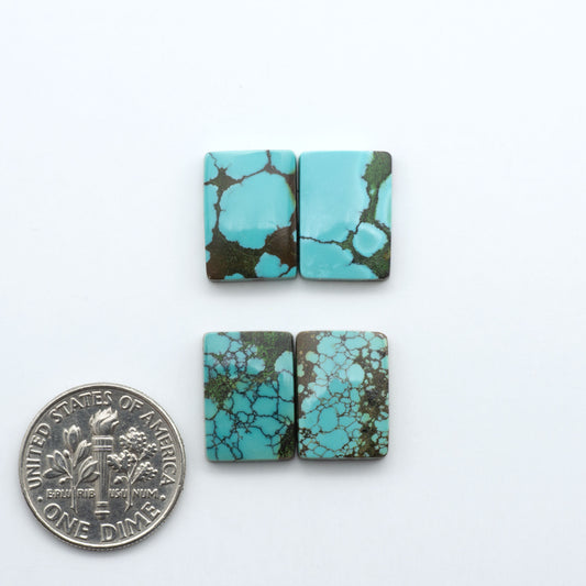 Hubei Cloud Mountain Turquoise cabochons, blue and green color with black matrix, polished stones on a white background, with a US dime for scale
