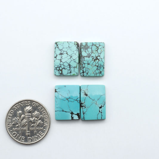 Hubei Cloud Mountain Turquoise cabochons, blue and green color with black matrix, polished stones on a white background, with a US dime for scale