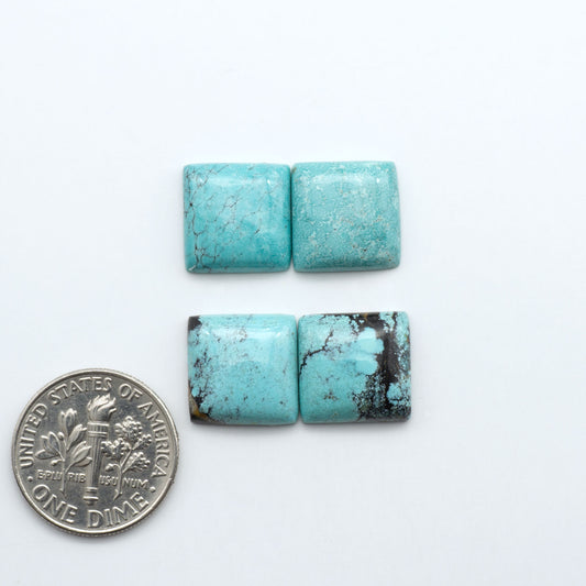 Hubei Cloud Mountain Turquoise cabochons, blue and green color with black matrix, polished stones on a white background, with a US dime for scale