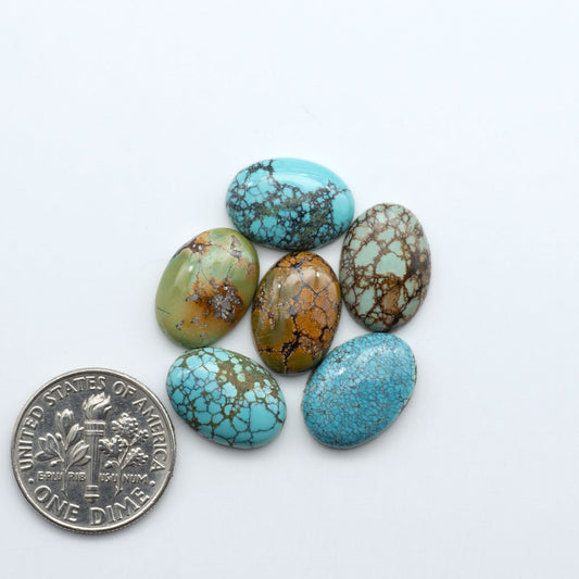 Hubei Cloud Mountain Turquoise cabochons, blue and green color with black matrix, polished stones on a white background, with a US dime for scale