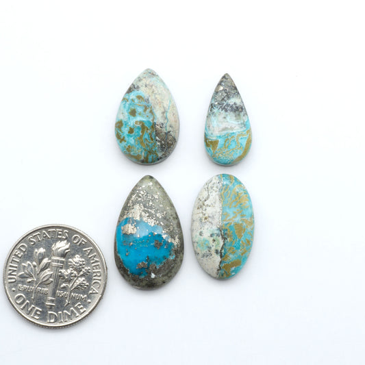 Royston Turquoise cabochons, blue-green color with natural matrix, polished stones on a white background, with a US dime for scale