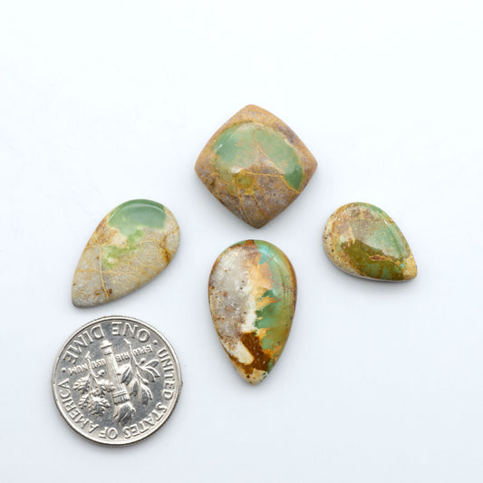 Royston Turquoise cabochons, blue-green color with natural matrix, polished stones on a white background, with a US dime for scale
