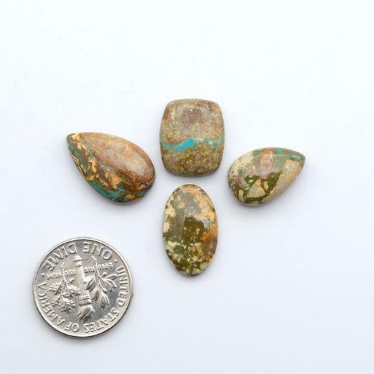 Royston Turquoise cabochons, blue-green color with natural matrix, polished stones on a white background, with a US dime for scale