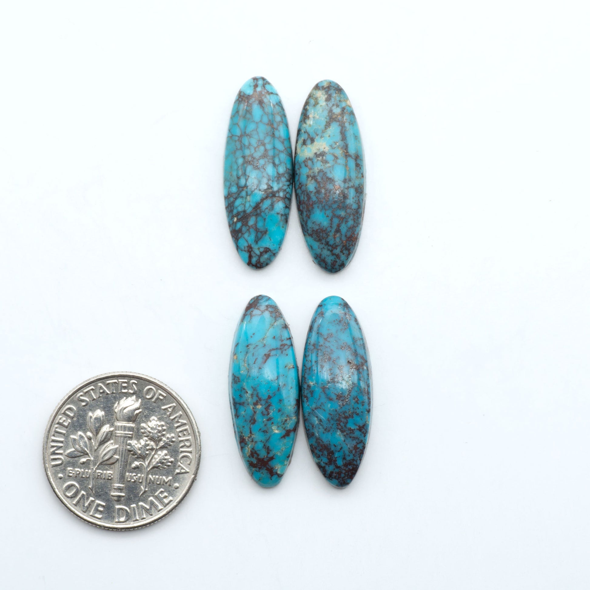 Hubei Cloud Mountain Turquoise cabochons, blue and green color with black matrix, polished stones on a white background, with a US dime for scale