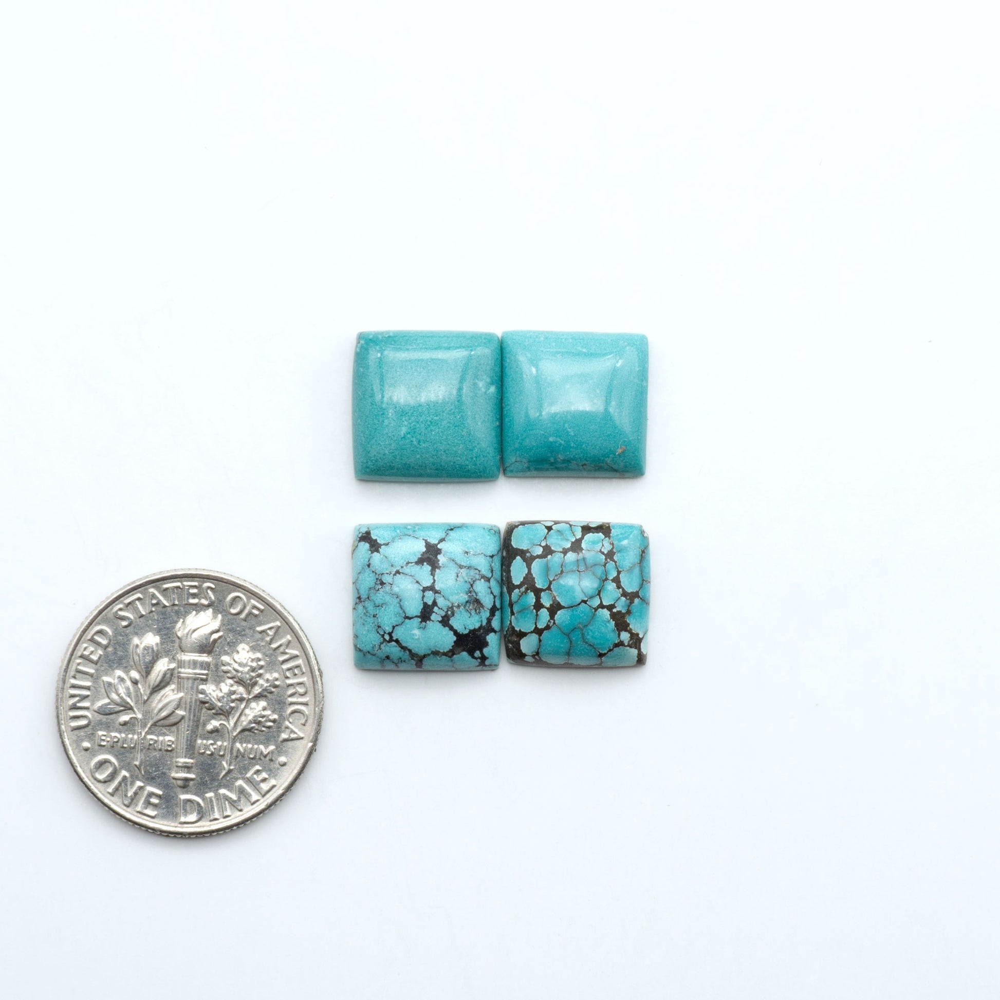Hubei Cloud Mountain Turquoise cabochons, blue and green color with black matrix, polished stones on a white background, with a US dime for scale