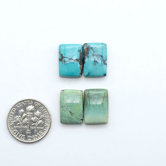 Hubei Cloud Mountain Turquoise cabochons, blue and green color with black matrix, polished stones on a white background, with a US dime for scale