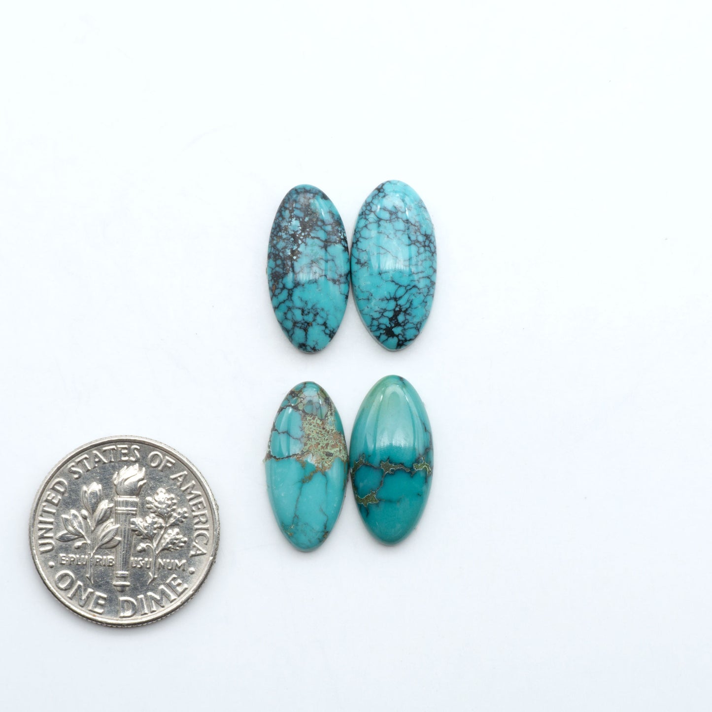 Hubei Cloud Mountain Turquoise cabochons, blue and green color with black matrix, polished stones on a white background, with a US dime for scale