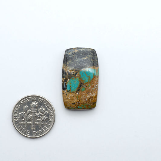 Black Jack turquoise cabochons, blue-green color with black matrix, polished stones on a white background with a US dime for scale