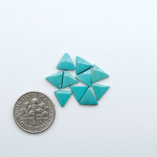 Hubei Cloud Mountain Turquoise cabochons, blue and green color with black matrix, polished stones on a white background with a US dime for scale