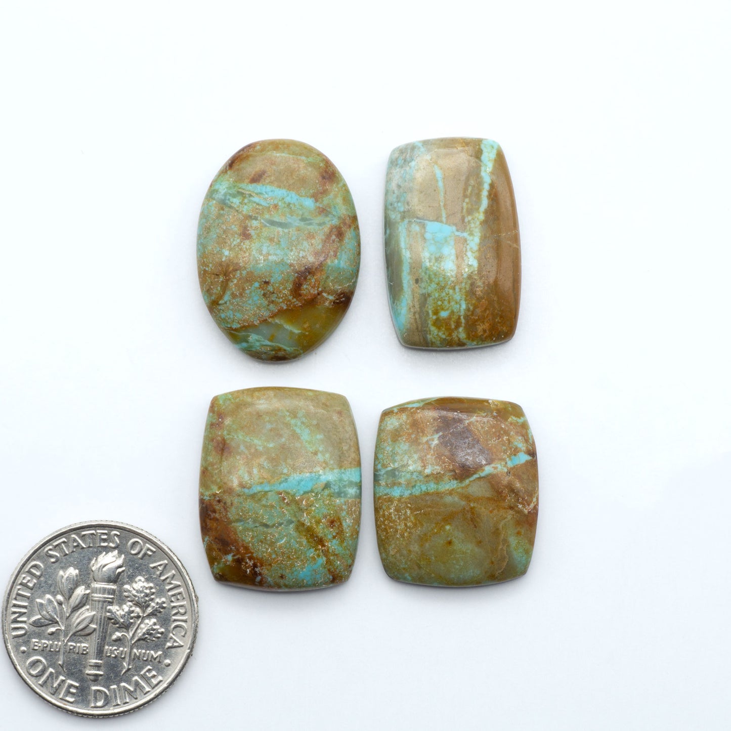 Number 8 Turquoise cabochons, blue and green color with brown matrix, polished stones on a white background, with a US dime for scale