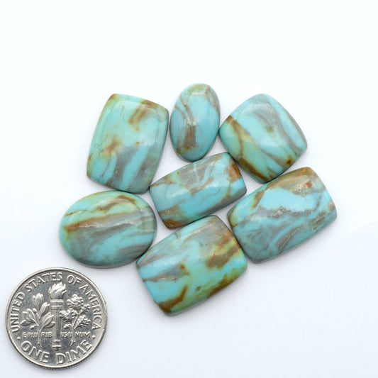 Number 8 Turquoise cabochons, blue and green color with brown matrix, polished stones on a white background, with a US dime for scale