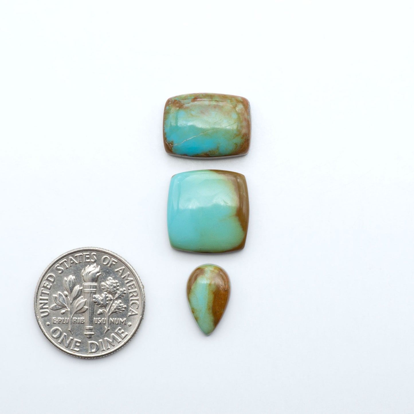 Number 8 Turquoise cabochons, blue and green color with brown matrix, polished stones on a white background, with a US dime for scale
