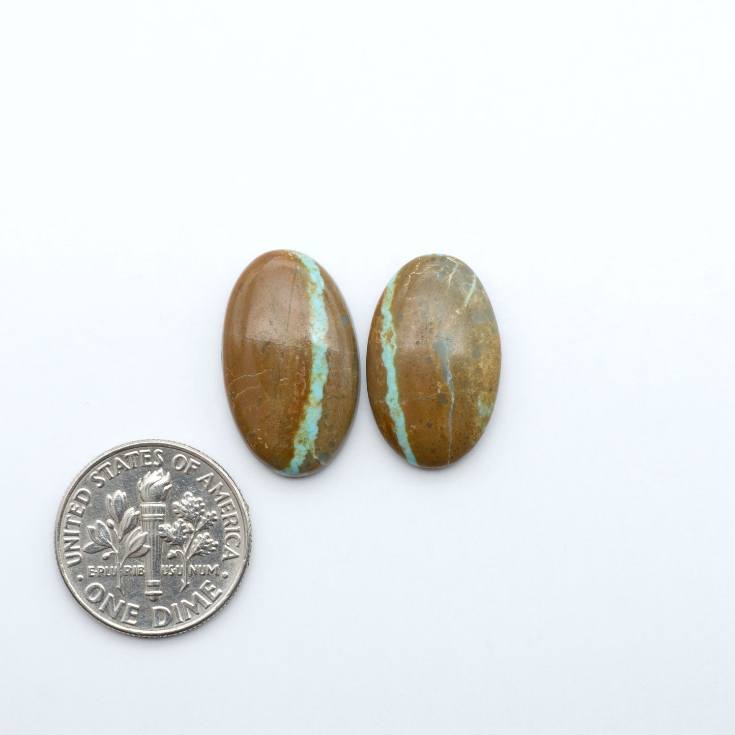 Number 8 Turquoise cabochons, blue and green color with brown matrix, polished stones on a white background, with a US dime for scale