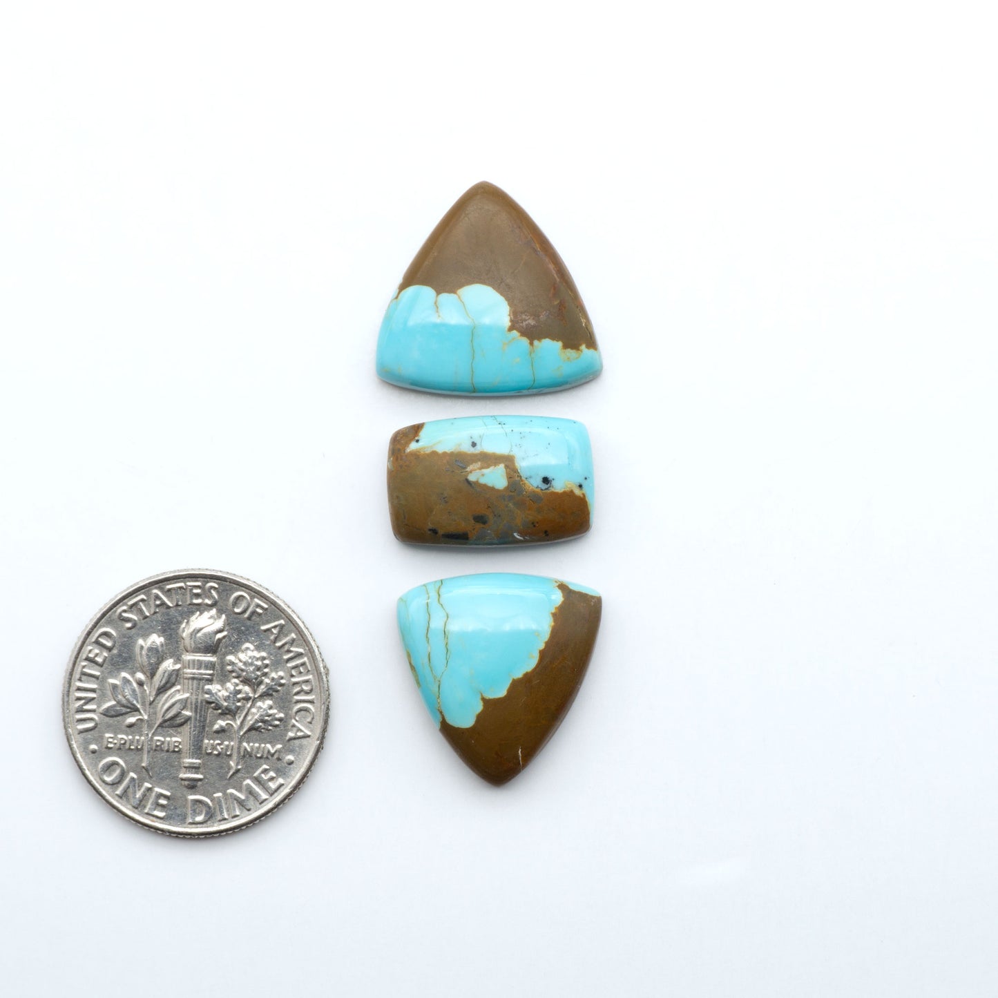 Number 8 Turquoise cabochons, blue and green color with brown matrix, polished stones on a white background, with a US dime for scale