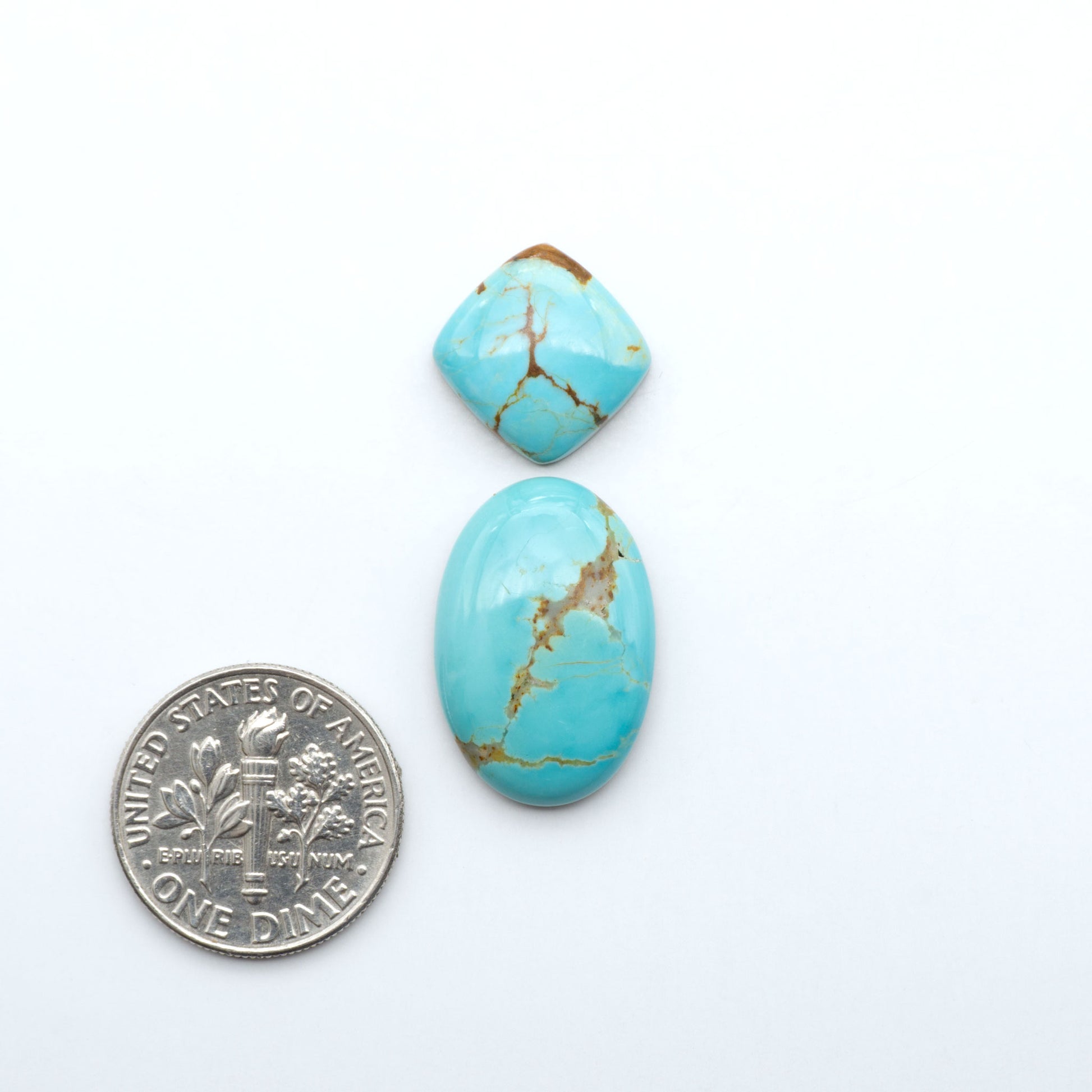 Number 8 Turquoise cabochons, blue and green color with brown matrix, polished stones on a white background, with a US dime for scale