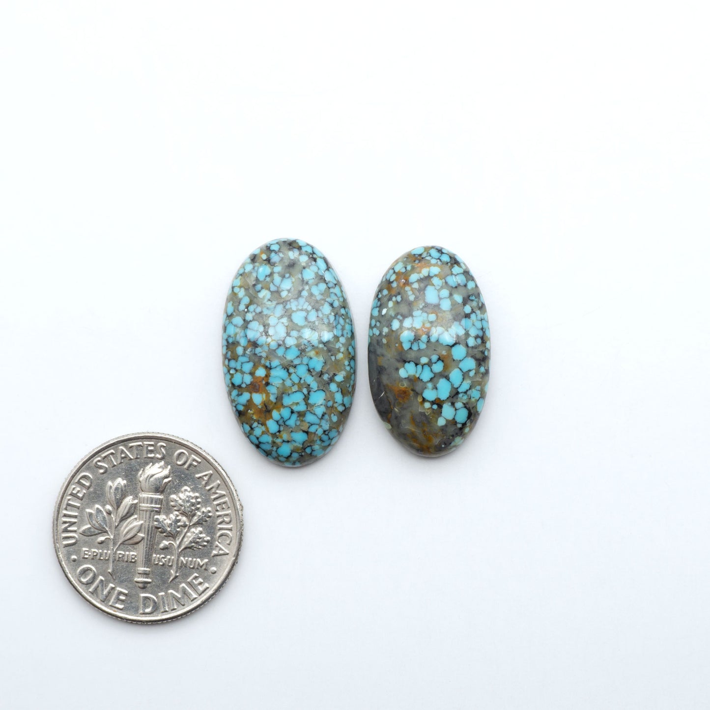 Number 8 Turquoise cabochons, blue and green color with brown matrix, polished stones on a white background, with a US dime for scale