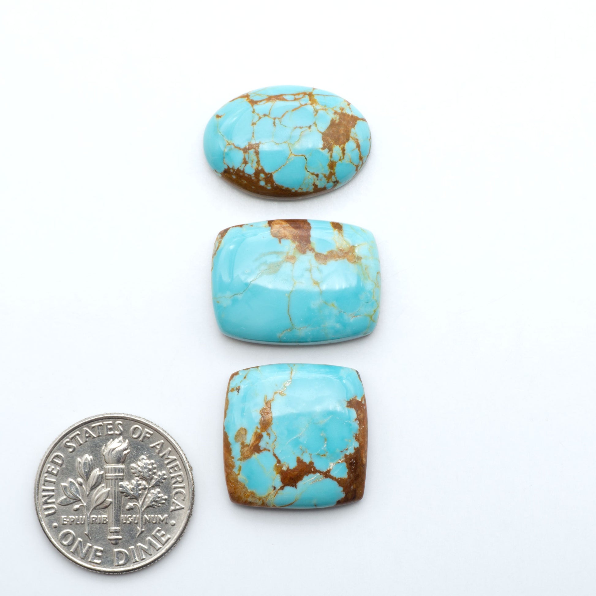 Number 8 Turquoise cabochons, blue and green color with brown matrix, polished stones on a white background, with a US dime for scale