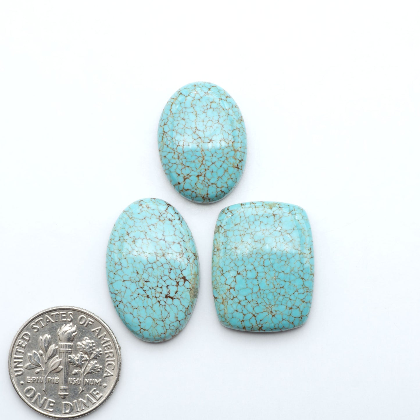 Number 8 Turquoise cabochons, blue and green color with brown matrix, polished stones on a white background, with a US dime for scale