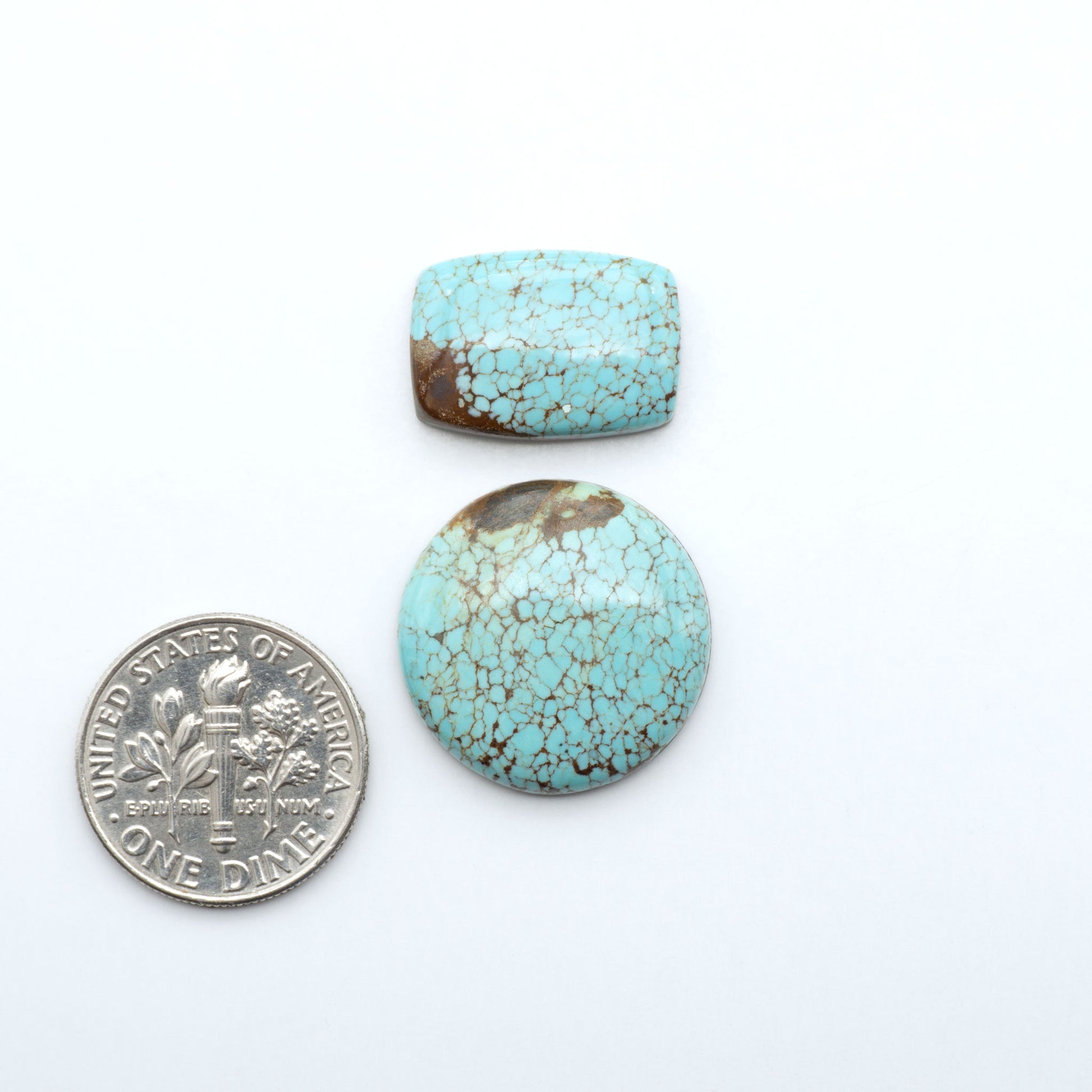 Number 8 Turquoise cabochons, blue and green color with brown matrix, polished stones on a white background, with a US dime for scale
