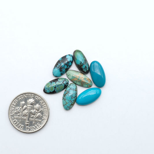 Hubei Cloud Mountain Turquoise cabochons, blue and green color with black matrix, polished stones on a white background with a US dime for scale