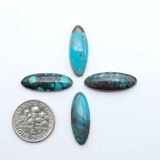 Hubei Cloud Mountain Turquoise cabochons, blue and green color with black matrix, polished stones on a white background with a US dime for scale
