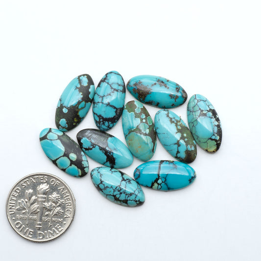 Hubei Cloud Mountain Turquoise cabochons, blue and green color with black matrix, polished stones on a white background with a US dime for scale
