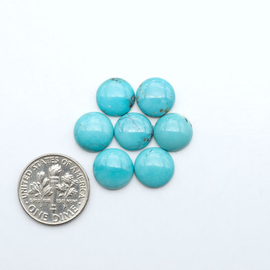 Hubei Cloud Mountain Turquoise cabochons, blue and green color with black matrix, polished stones on a white background with a US dime for scale
