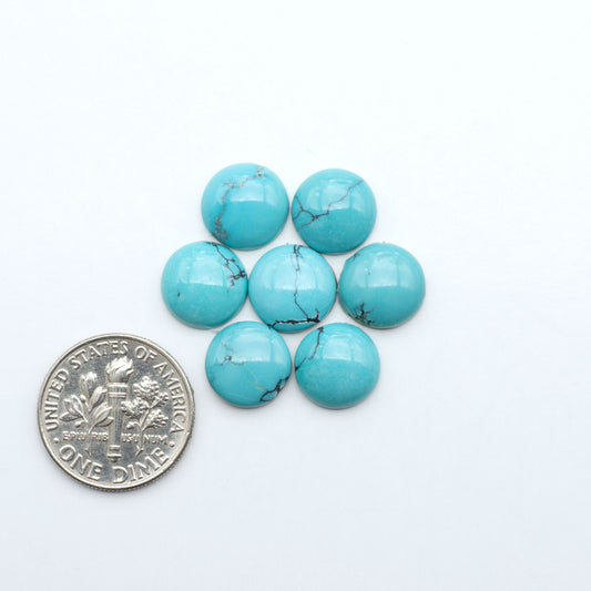 Hubei Cloud Mountain Turquoise cabochons, blue and green color with black matrix, polished stones on a white background with a US dime for scale