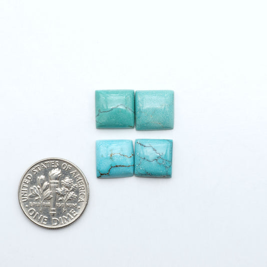 Hubei Cloud Mountain Turquoise cabochons, blue and green color with black matrix, polished stones on a white background with a US dime for scale