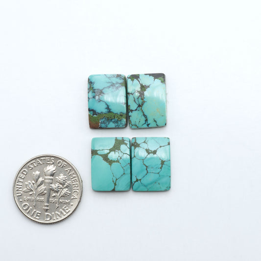 Hubei Cloud Mountain Turquoise cabochons, blue and green color with black matrix, polished stones on a white background with a US dime for scale