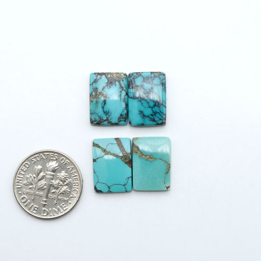 Hubei Cloud Mountain Turquoise cabochons, blue and green color with black matrix, polished stones on a white background with a US dime for scale
