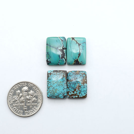 Hubei Cloud Mountain Turquoise cabochons, blue and green color with black matrix, polished stones on a white background with a US dime for scale