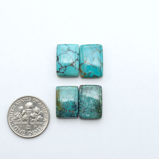 Hubei Cloud Mountain Turquoise cabochons, blue and green color with black matrix, polished stones on a white background with a US dime for scale