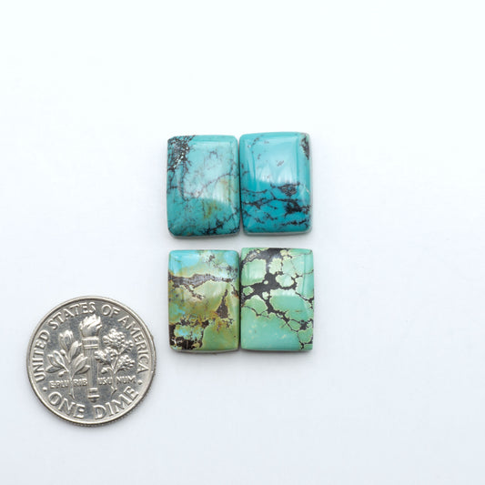 Hubei Cloud Mountain Turquoise cabochons, blue and green color with black matrix, polished stones on a white background with a US dime for scale