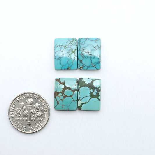 Hubei Cloud Mountain Turquoise cabochons, blue and green color with black matrix, polished stones on a white background with a US dime for scale