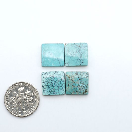 Hubei Cloud Mountain Turquoise cabochons, blue and green color with black matrix, polished stones on a white background with a US dime for scale