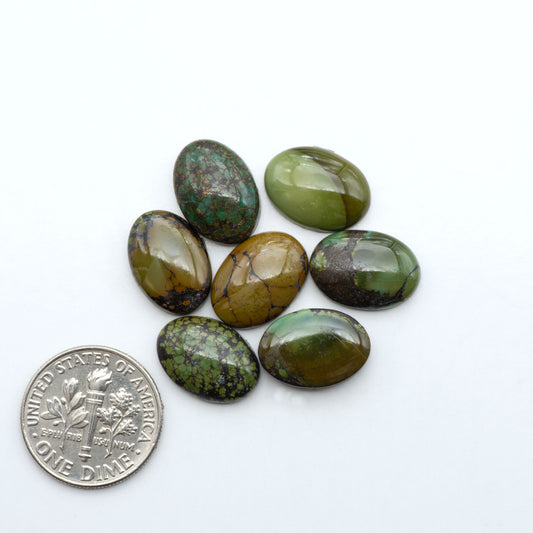 Hubei Cloud Mountain Turquoise cabochons, blue and green color with black matrix, polished stones on a white background with a US dime for scale