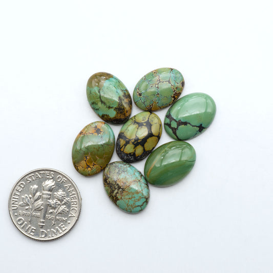 Hubei Cloud Mountain Turquoise cabochons, blue and green color with black matrix, polished stones on a white background with a US dime for scale