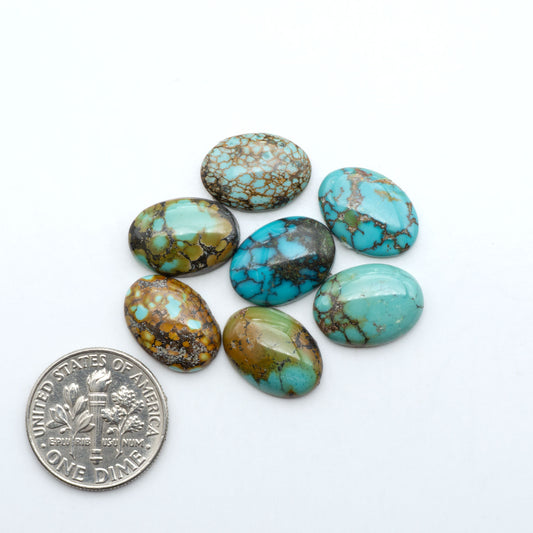 Hubei Cloud Mountain Turquoise cabochons, blue and green color with black matrix, polished stones on a white background with a US dime for scale