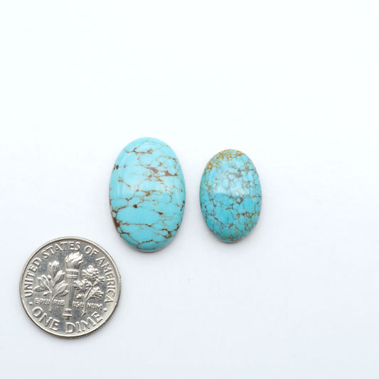 Number 8 Turquoise cabochons, blue and green color with brown matrix, polished stones on a white background, with a US dime for scale
