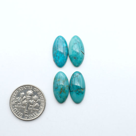Hubei Cloud Mountain Turquoise cabochons, blue and green color with black matrix, polished stones on a white background with a US dime for scale