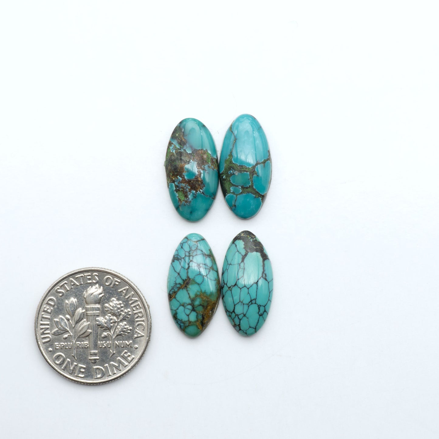 Hubei Cloud Mountain Turquoise cabochons, blue and green color with black matrix, polished stones on a white background with a US dime for scale