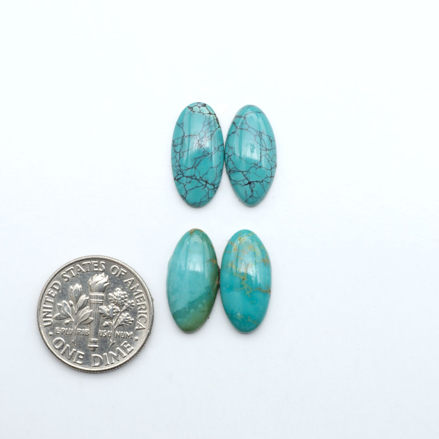 Hubei Cloud Mountain Turquoise cabochons, blue and green color with black matrix, polished stones on a white background with a US dime for scale