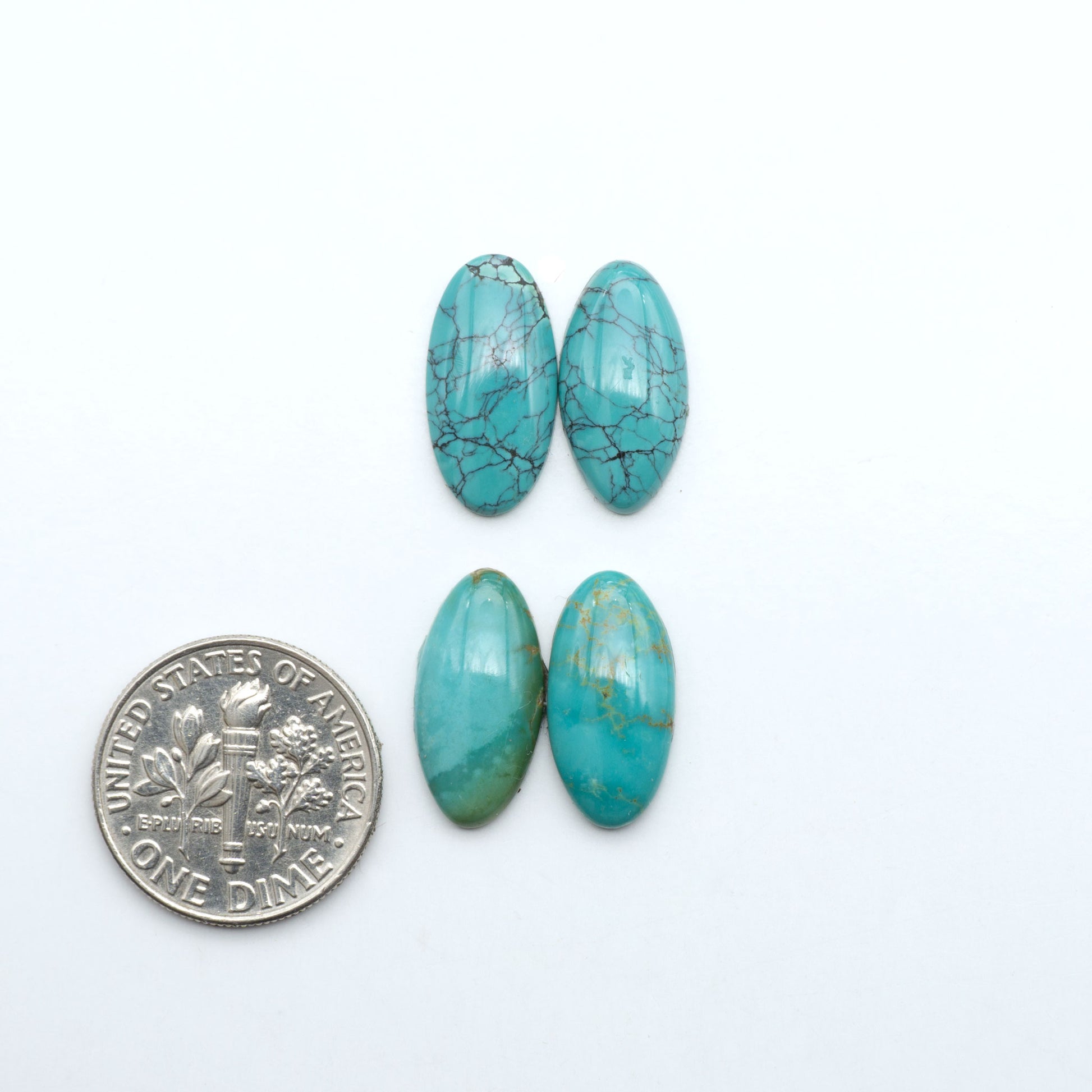 Hubei Cloud Mountain Turquoise cabochons, blue and green color with black matrix, polished stones on a white background with a US dime for scale