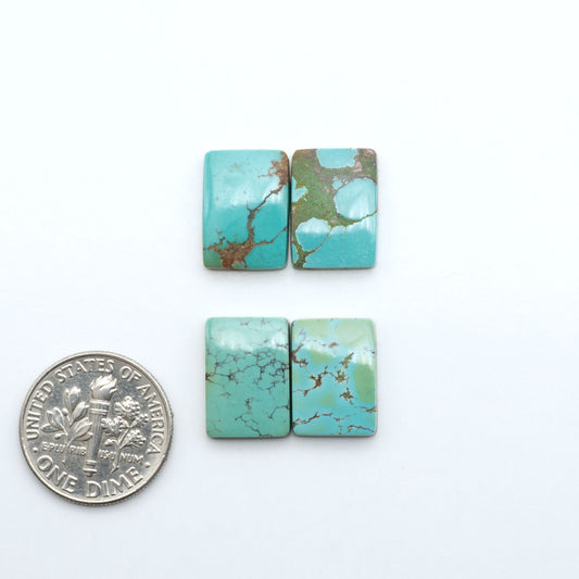 Hubei Cloud Mountain Turquoise cabochons, blue and green color with black matrix, polished stones on a white background with a US dime for scale