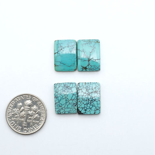Hubei Cloud Mountain Turquoise cabochons, blue and green color with black matrix, polished stones on a white background with a US dime for scale
