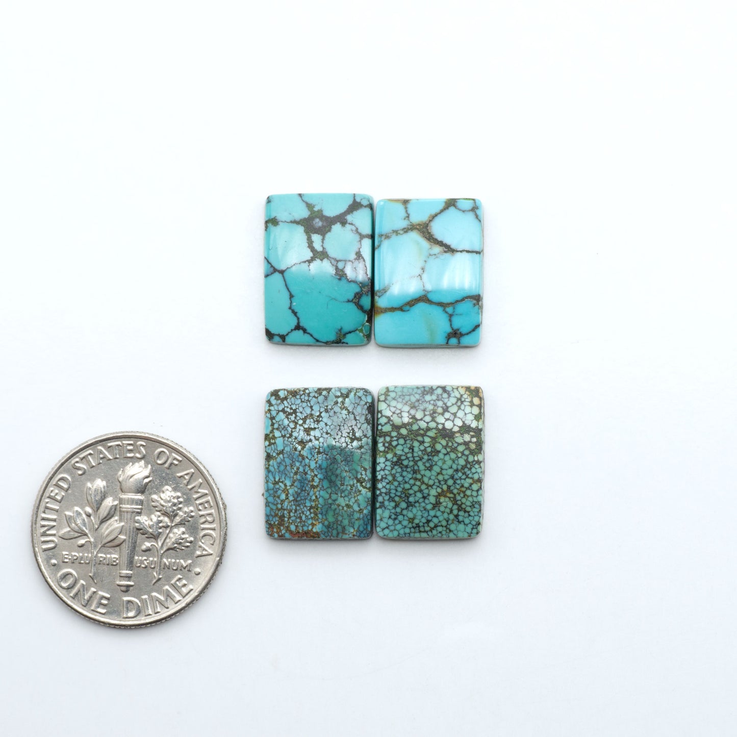 Hubei Cloud Mountain Turquoise cabochons, blue and green color with black matrix, polished stones on a white background with a US dime for scale