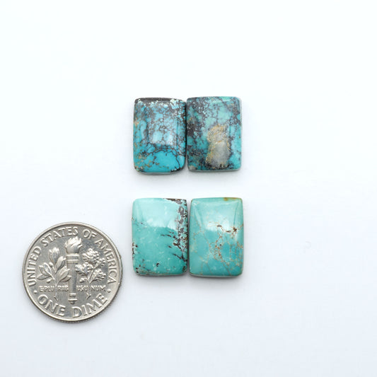 Hubei Cloud Mountain Turquoise cabochons, blue and green color with black matrix, polished stones on a white background with a US dime for scale