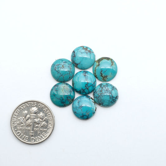 Hubei Cloud Mountain Turquoise cabochons, blue and green color with black matrix, polished stones on a white background with a US dime for scale