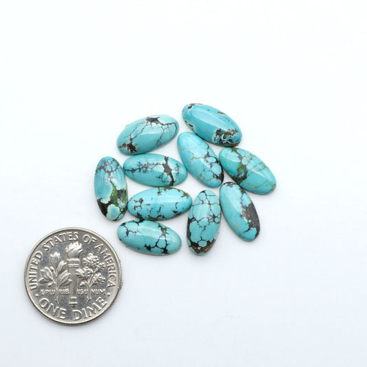 Hubei Cloud Mountain Turquoise cabochons, blue and green color with black matrix, polished stones on a white background with a US dime for scale